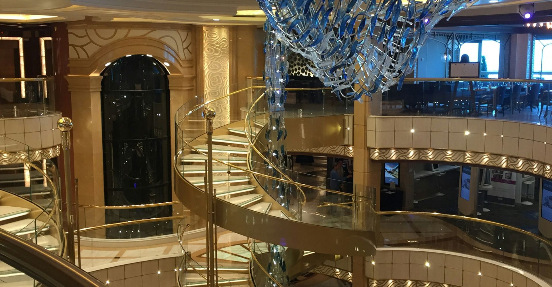Atrium of a cruise ship with a glass staircase